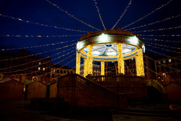 Evening lights illuminate Plaza del Castillo in Pamplona, Navarra, Spain during a festive atmosphere