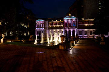 Colorful fountain display at night in Pamplona Navarra highlighting architectural beauty and serene...