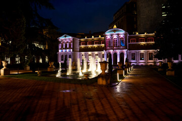 Beautiful fountain display at night in Pamplona Navarra with illuminated historic building