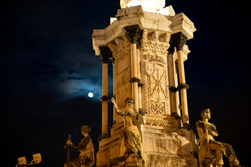 Monumento a los Fueros shines under the moonlit sky in Pamplona, Navarra, Spain, showcasing...