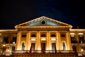 Illuminated facade of the historic city hall in Pamplona, Navarra during an evening event