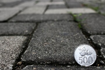 500 hundred Rupiah coin on the road