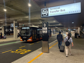 Tourists at Auckland airport bus stop New Zealand