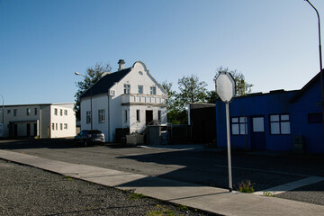 Residential street scene in Akranes, Iceland under bright sunlight and blue sky