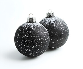 Two black Christmas ornaments, dusted with white glitter, on a bright white background.