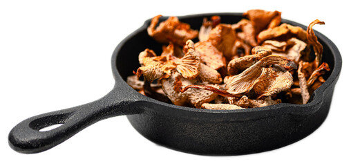 Organic dried mushrooms mix of chanterelles and porcini in a black skillet isolated on transparent...
