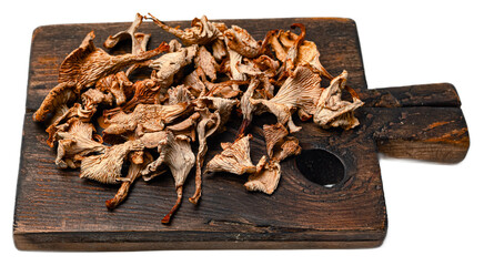 Gourmet dried wild forest mushrooms mix chanterelles and porcini on rustic wooden board with...