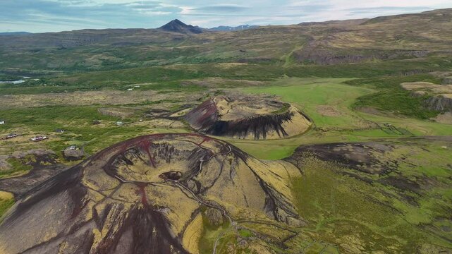 Explore the stunning Grabrok Crater, a striking volcanic formation in Iceland. The colorful ridges and lush surroundings offer a captivating view of natures artistry at any time of day.