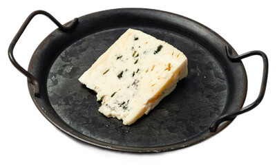 Aged blue cheese wedge with moldy veins on a dark round slate served on a rustic black plate,...