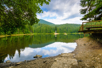 remote mountain landscape with forest lake in summer. travel nature background of synevyr national...