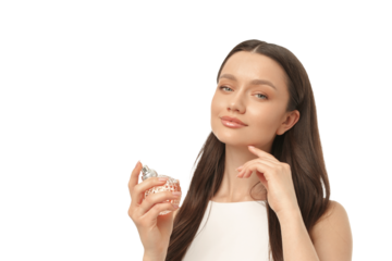 Woman showcasing a perfume bottle with a smile, isolated on white, PNG