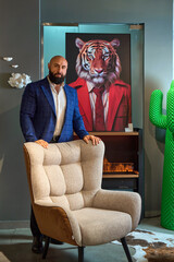 A stylish bearded man in a business suit in an interior