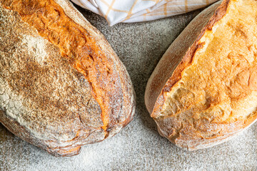 Freshly baked artisan bread loaves on a rustic countertop with flour dusting in a cozy kitchen
