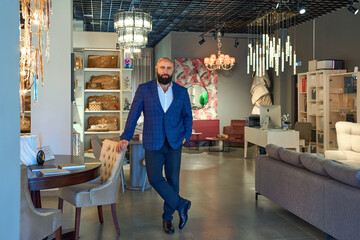 A stylish bearded man in a business suit in an interior