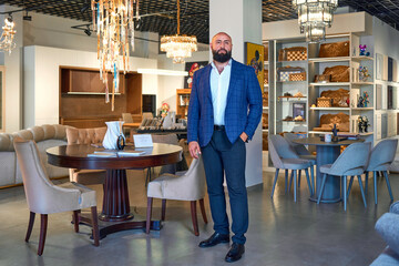 A stylish bearded man in a business suit in an interior