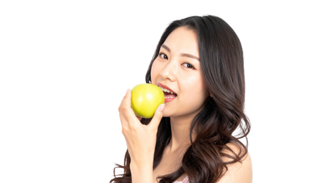 Eating a green apple woman in a studio setting lifestyle portrait freshness and health concept - Powered by Adobe
