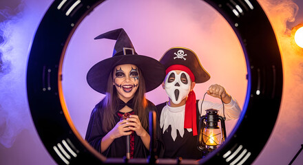 Girls in Witch and Ghost Costumes Holding Lantern
