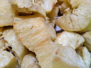 Fried cassava, golden yellow in color and crispy texture can be seen filling the entire frame,...
