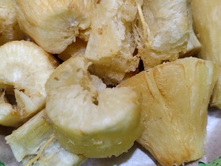 Fried cassava, golden yellow in color and crispy texture can be seen filling the entire frame,...