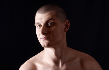 Portrait of a Young Man Against a Black Studio Background