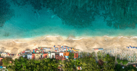 Top Aerial view of famous Virgin Beach in Bali, Indonesia. Empty paradise beach, blue sea waves in...