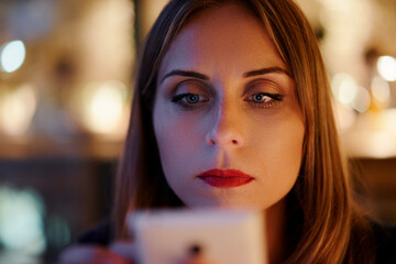 Focused Woman Using Smartphone Against a Vibrant Background