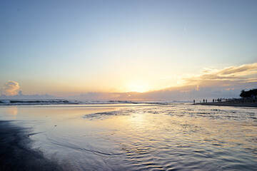 Scenic Beach Sunset with Gentle Waves and Clear Sky
