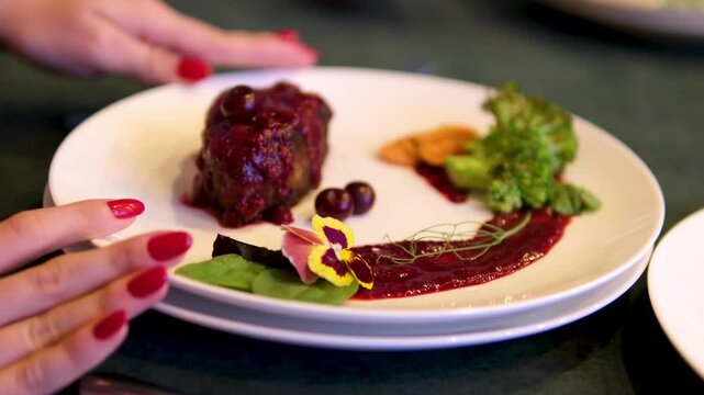 modern presentations of haute cuisine, European food establishments, restaurants with Michelin star. minimalist decoration. with cherry sauce meat beautiful serving with edible flowers