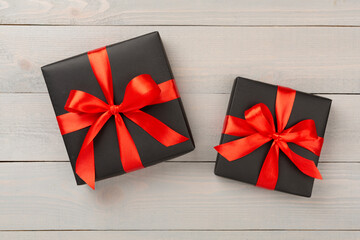 Black gift boxes on wooden background, top view. Black Friday concept