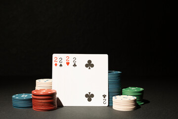 Poker chips and playing cards on table