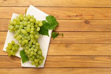 Fresh green grape on wooden background, top view