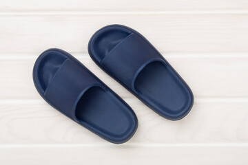 Blue sandals on wooden background,top view