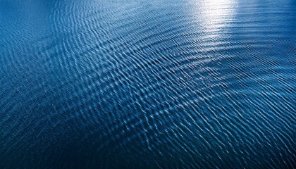 vertical dark blue water surface with ripples background top view