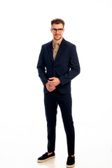 Portrait of a young business man standing against isolated bacgkround