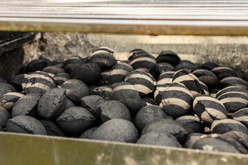 Close up of charcoal briquettes in a grill.