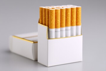 Pack of cigarettes arranged neatly in a white box on a gray surface