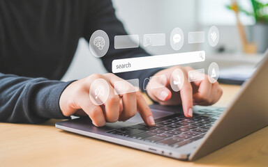 Person typing on laptop with digital icons technology
