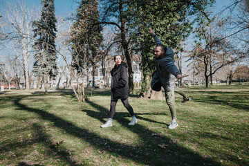 Teenagers enjoying the sunny day, spending time together at the park. Their interaction conveys...