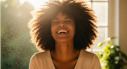 Close-up of a young woman with curly brown hair, eyes closed, laughing joyfully in sunlight, dust motes visible, conveying happiness and carefree joy