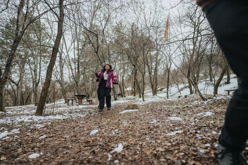 A group of friends spends time together in a snowy woodland setting, embracing the joy of nature...