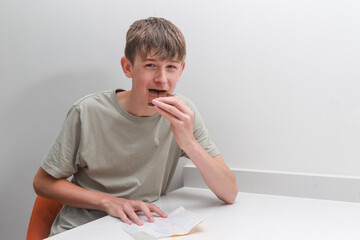 Teen boy eating chocolate