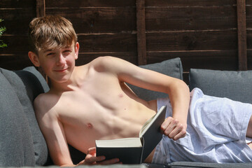 Teenage Boy Reading Outside