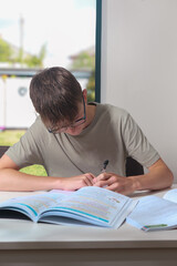 Teenage boy doing home work