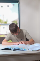 Teenage boy doing home work