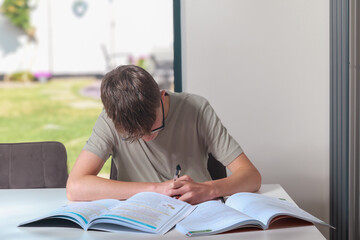 Teenage boy doing home work