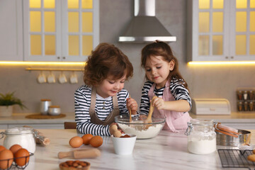 Cooking recipe. Cute children making dough for cookies at table in kitchen