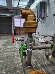 Industrial water pipe with Automatic Air Vent brass valve head placed in factory setting, ideal for...