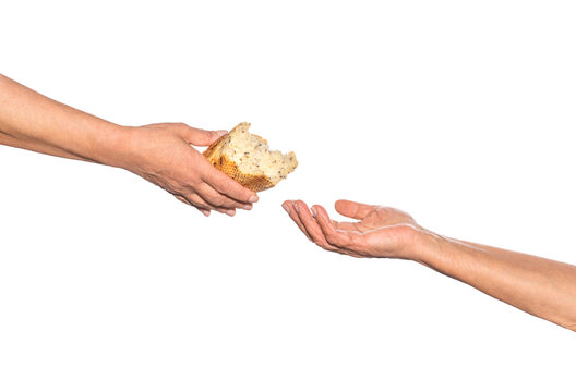 Old man giving poor homeless person pieces of bread. Helping the homeless. Elder woman hand give a loaf of bread to hands of a beggar. Poverty and world hunger concept. Hands grabbing for bread
