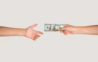 Handling 100 dollar bill of cash to other hand. Man giving dollar banknotes to woman. Male hand...