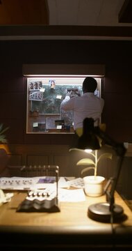 The detective puts the crime photos on the board. The process of solving a crime